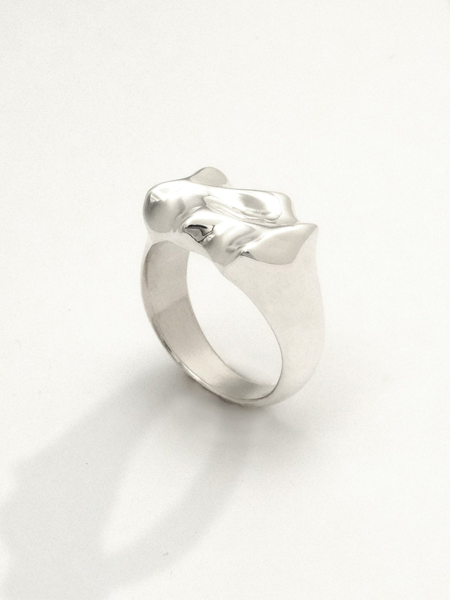 Close-up of a sterling silver ring featuring a liquid-like texture design with a mirror shine finish. The ring is 12mm wide at its widest point.