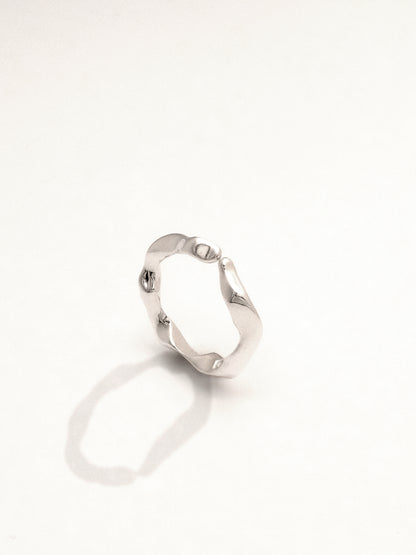 The same sterling silver ring as the previous images cleanly lit and from a top down three quarter view giving another sense of its organic and water-like form